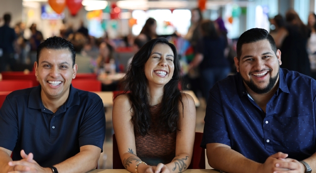 Photo of three Achieve employees laughing