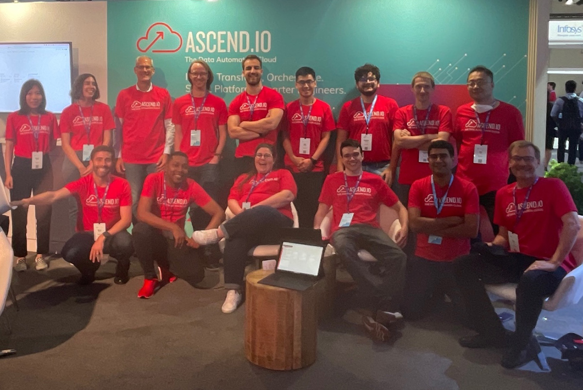 Ascend group photo with team members wearing matching red t-shirts with the company logo