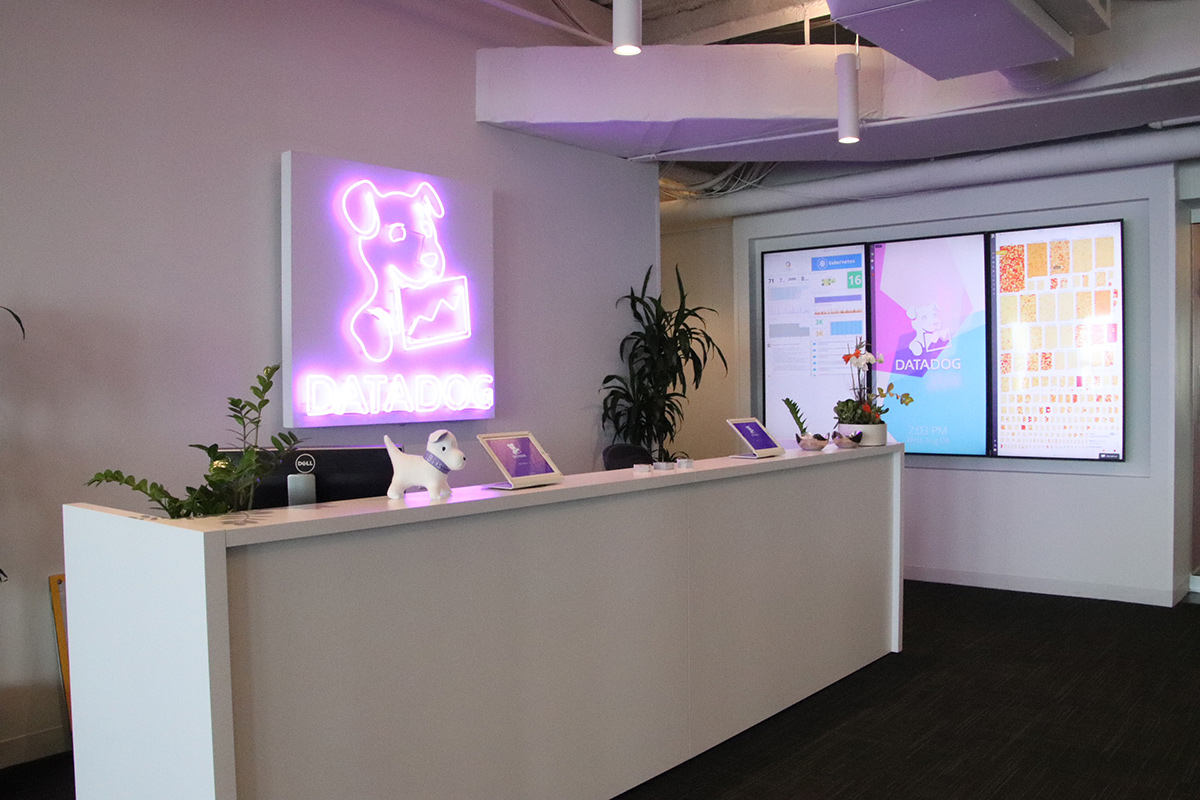 The front desk at Datadog with a neon company sign.