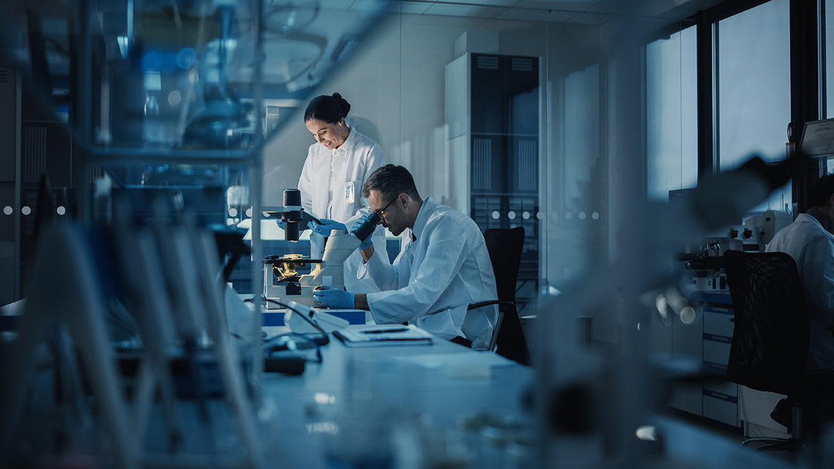 Two scientists working in a modern medical research lab