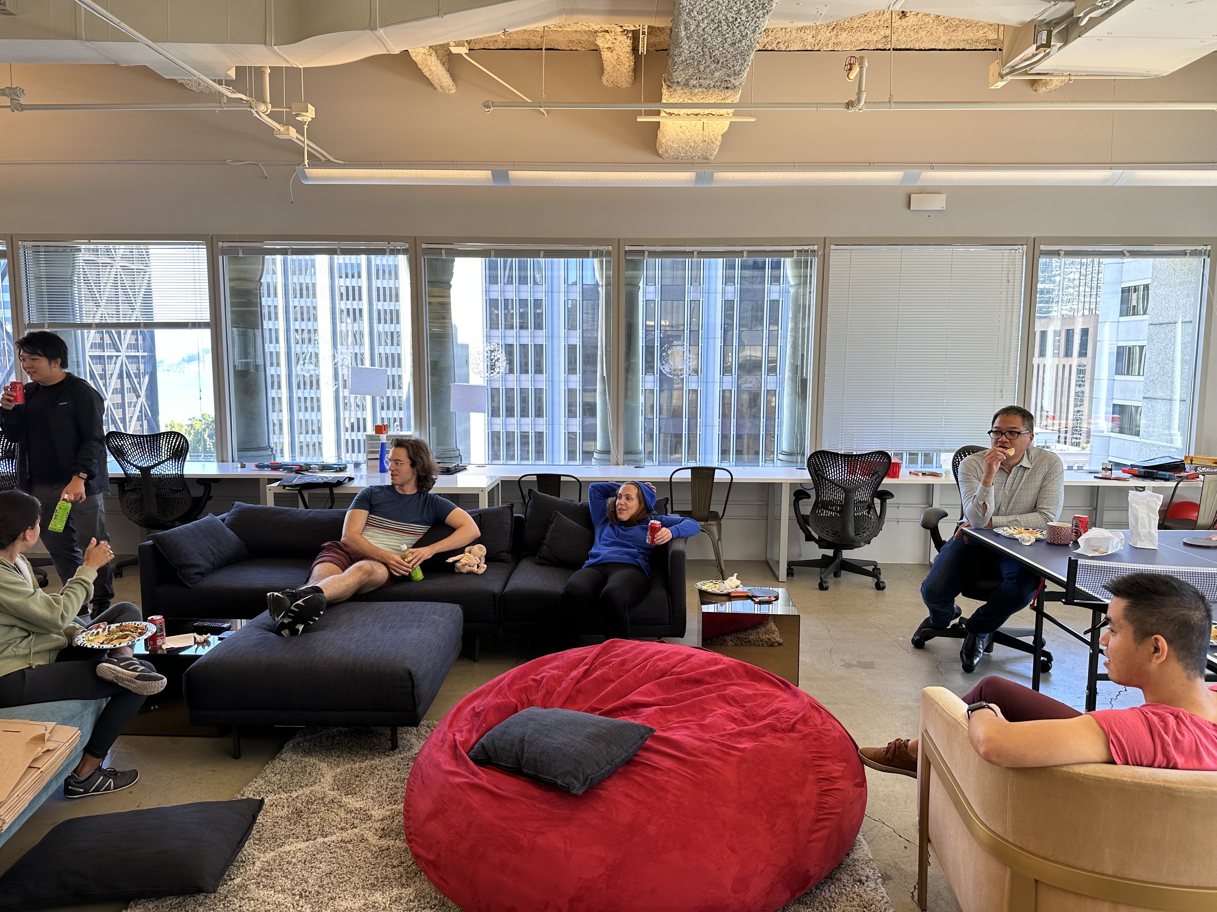 The Unit21 team networking in a lounge at the company's San Francisco office