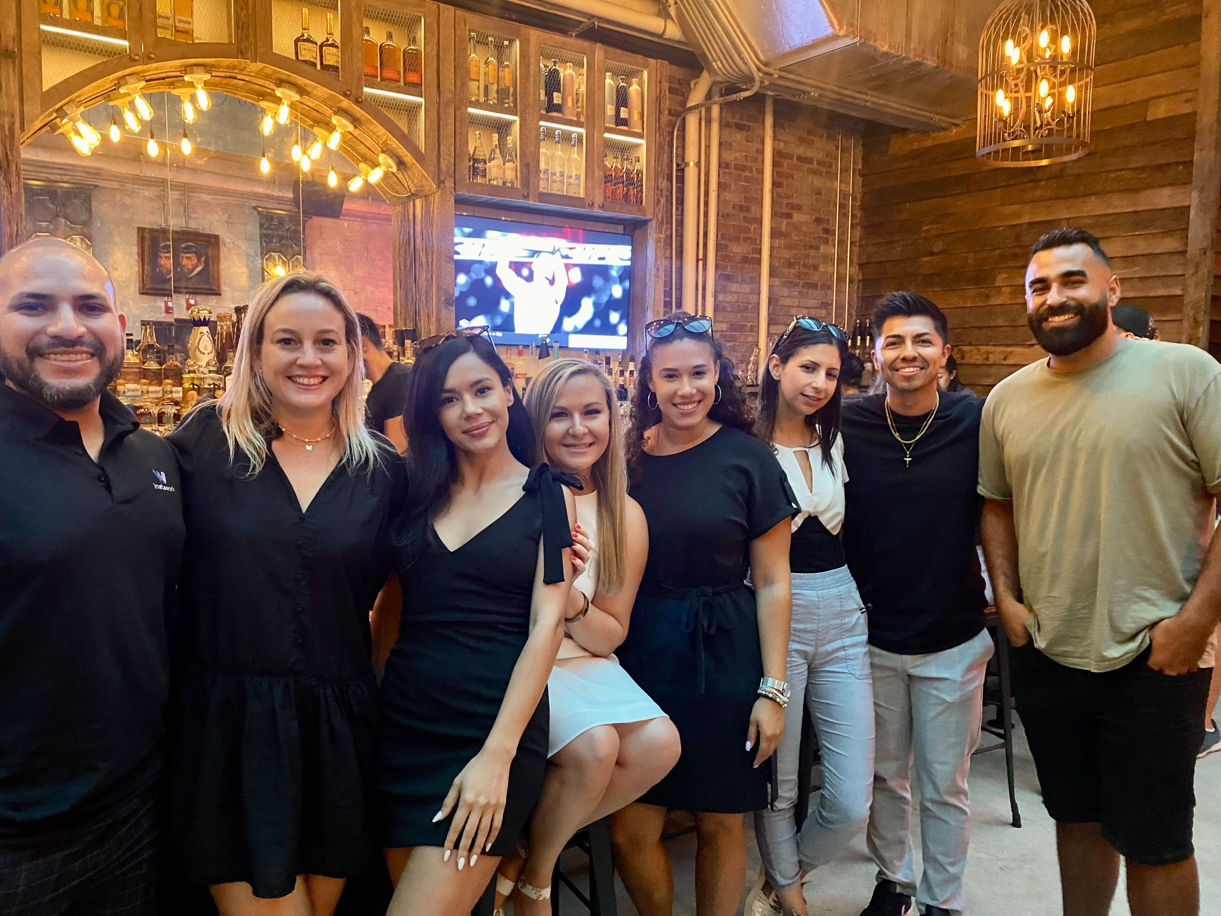 A group of Instawork employees stand inside a restaurant
