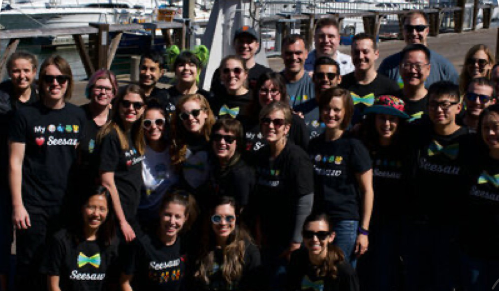 Seesaw group photo with team members wearing matching company t-shirts