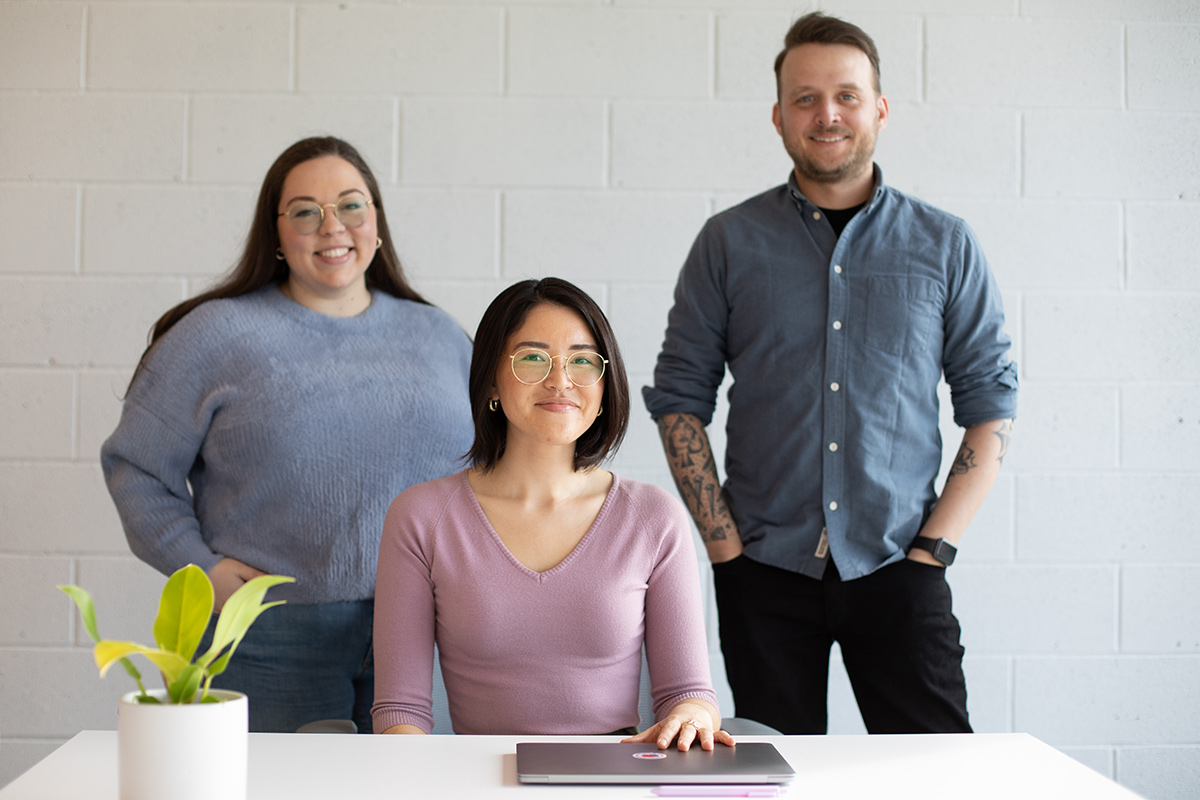 Three Wix team members standing together in the office