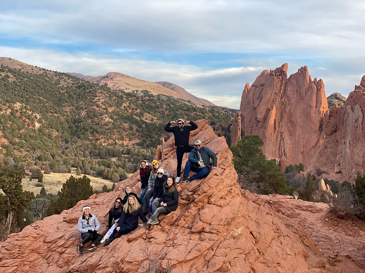 Wix team members at the top of a red rock mountain