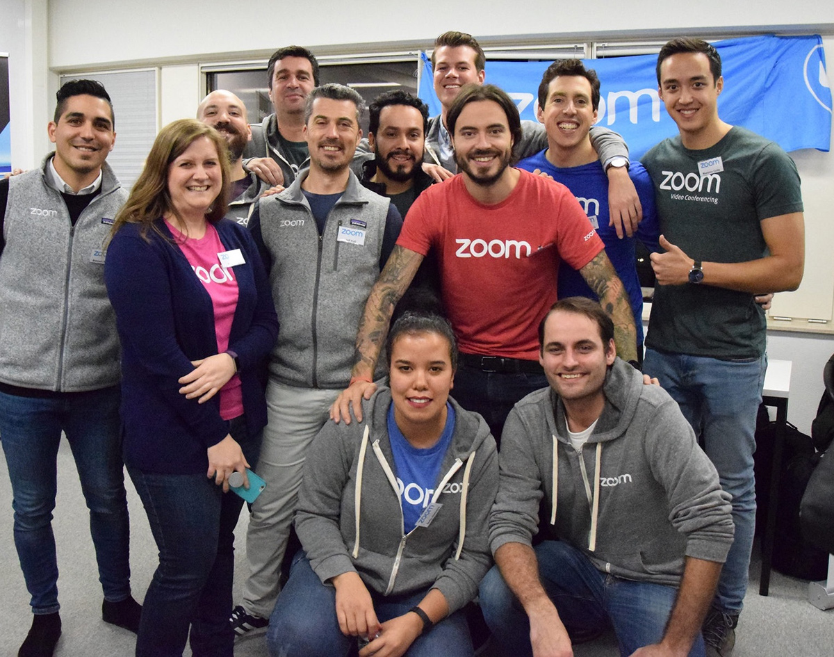 Zoom team members wearing Zoom t-shirts and jackets