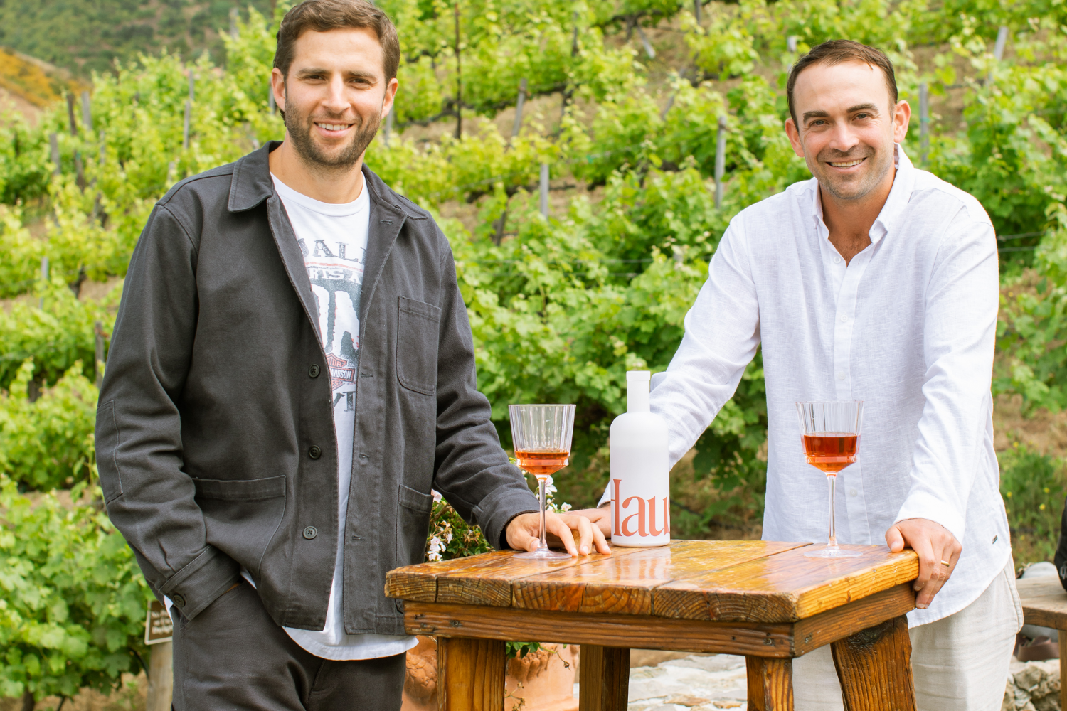 The Naked Market co-founders Harrison Fugman and Alex Kost pose for a photo with Haus brand drinks.