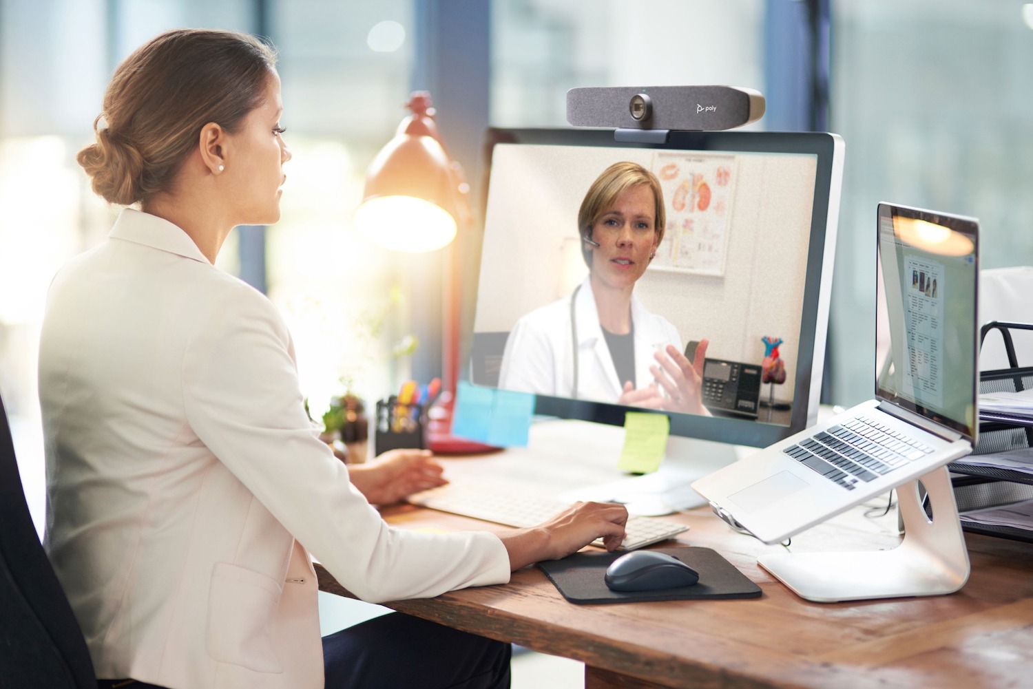 A healthcare professional uses the PolyStudio P15 personal video bar.