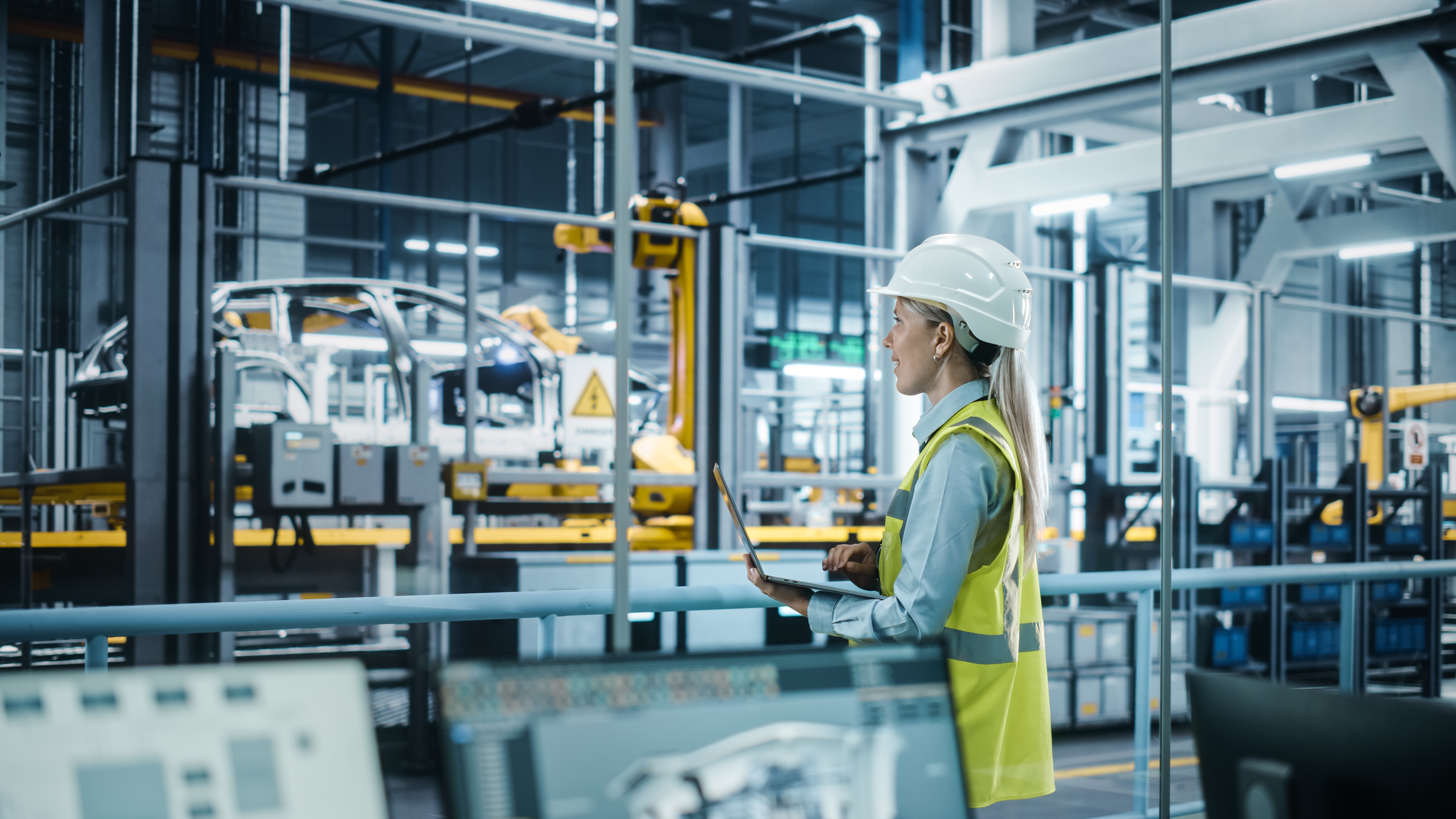 stock photo of someone working in a high-tech factory wearing a reflective vest