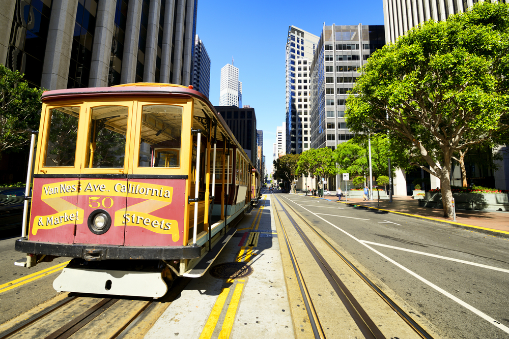 A cable car travels down a steep hill in San Francisco.