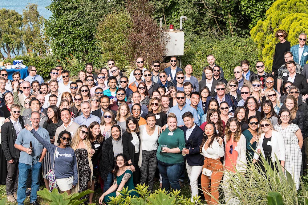 A large group of Newfront employees pose outside in San Francisco