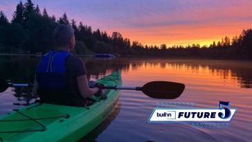 Limitless Guided Visualization's CEO Cali Chill in a kayak at sunset.