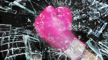 A pink boxing glove shatters glass