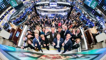 A panoramic photo of the Planet team members at a Nasdaq listing event.