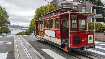 photo of SF cable car in the street on an overcast day